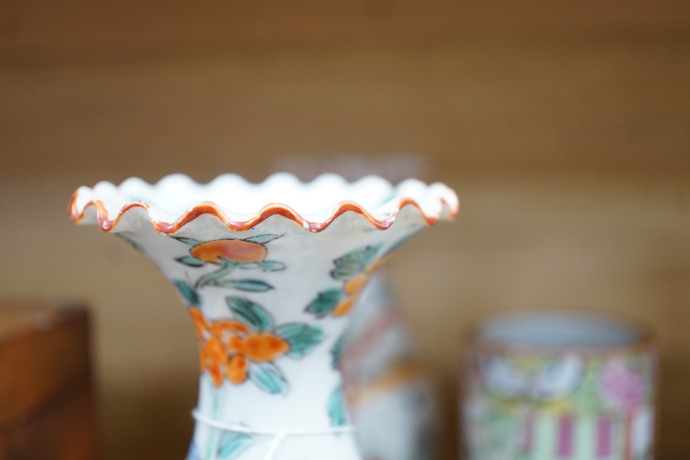 A pair of 19th century Cantonese famille rose porcelain brushpots, decorated with figural scenes, together with a further pair of Japanese export vases (4)